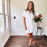 Lined cream denim-like short shift dress with V neck and collar, short sleeves,, contrasting tan stitching, front pocket and eyelet details throughout