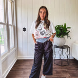 White oversized tee featuring a mixed print of black, red and cream in western, leo and playing card theme.