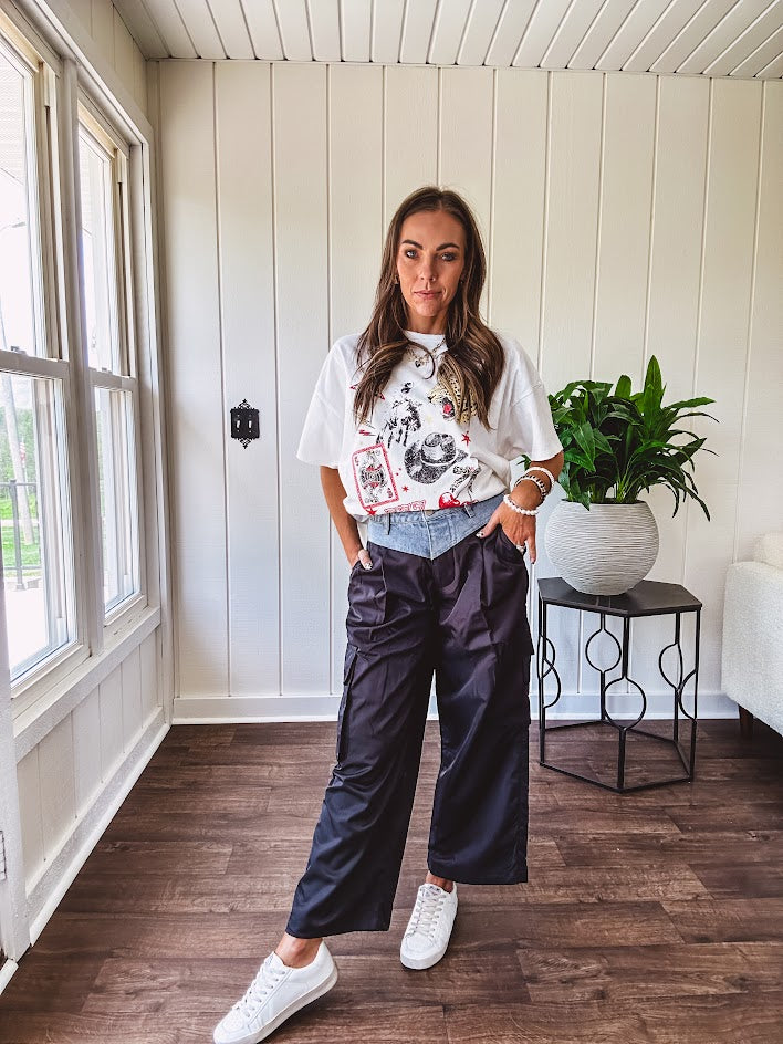 White oversized tee featuring a mixed print of black, red and cream in western, leo and playing card theme.