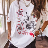 White oversized tee featuring a mixed print of black, red and cream in western, leo and playing card theme.