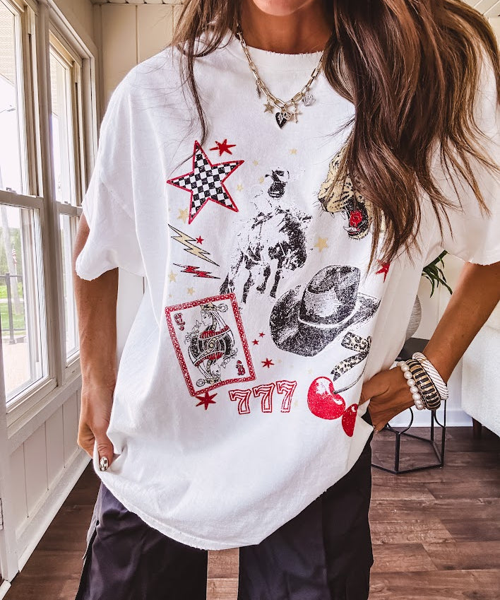 White oversized tee featuring a mixed print of black, red and cream in western, leo and playing card theme.