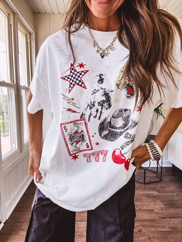 White oversized tee featuring a mixed print of black, red and cream in western, leo and playing card theme.