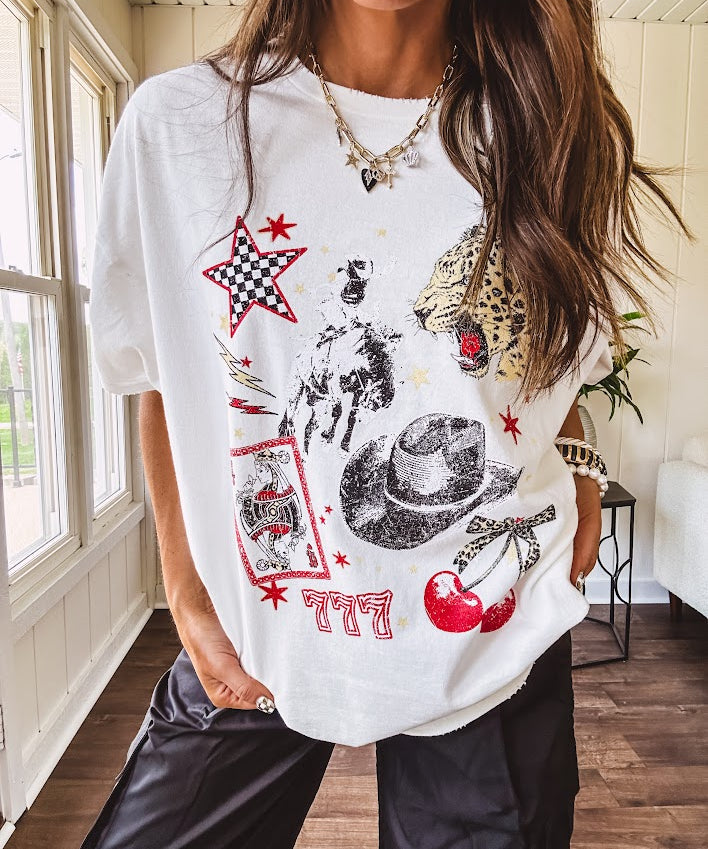 White oversized tee featuring a mixed print of black, red and cream in western, leo and playing card theme.