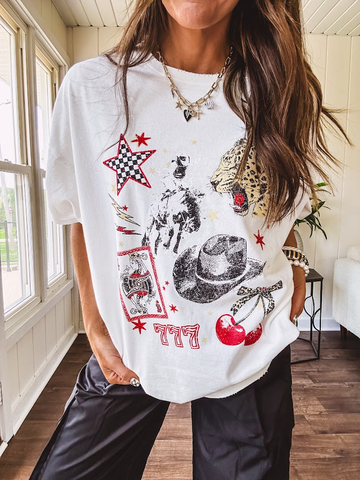 White oversized tee featuring a mixed print of black, red and cream in western, leo and playing card theme.