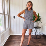 Sleeveless black and white gingham vest with fabric buttons down the front.