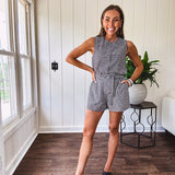 Sleeveless black and white gingham vest with fabric buttons down the front.