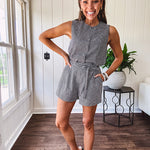 Sleeveless black and white gingham vest with fabric buttons down the front.
