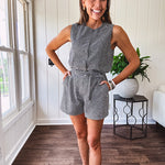 Sleeveless black and white gingham vest with fabric buttons down the front.