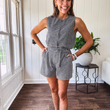 Sleeveless black and white gingham vest with fabric buttons down the front.