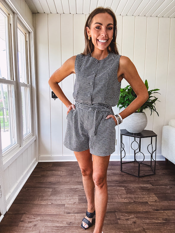 Sleeveless black and white gingham vest with fabric buttons down the front.