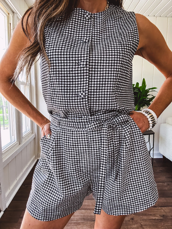 Sleeveless black and white gingham vest with fabric buttons down the front.