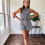 Sleeveless black and white gingham vest with fabric buttons down the front.