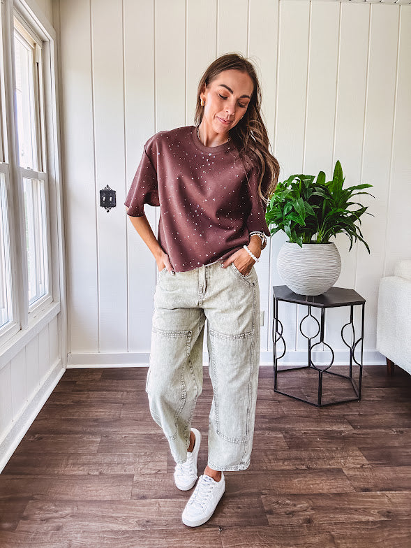Mineral washed light olive denim barrel pants with carpenter design, side pockets and button and zipper closure with elastic back waist.