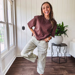 Mineral washed light olive denim barrel pants with carpenter design, side pockets and button and zipper closure with elastic back waist.