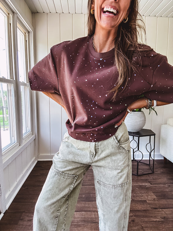 Cotton brown tee with a boxy cut and tie dyed underlayment peeking out of star cutouts, adorned with multicolor mini crystals.