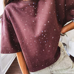 Cotton brown tee with a boxy cut and tie dyed underlayment peeking out of star cutouts, adorned with multicolor mini crystals.