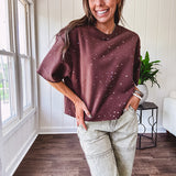 Cotton brown tee with a boxy cut and tie dyed underlayment peeking out of star cutouts, adorned with multicolor mini crystals.