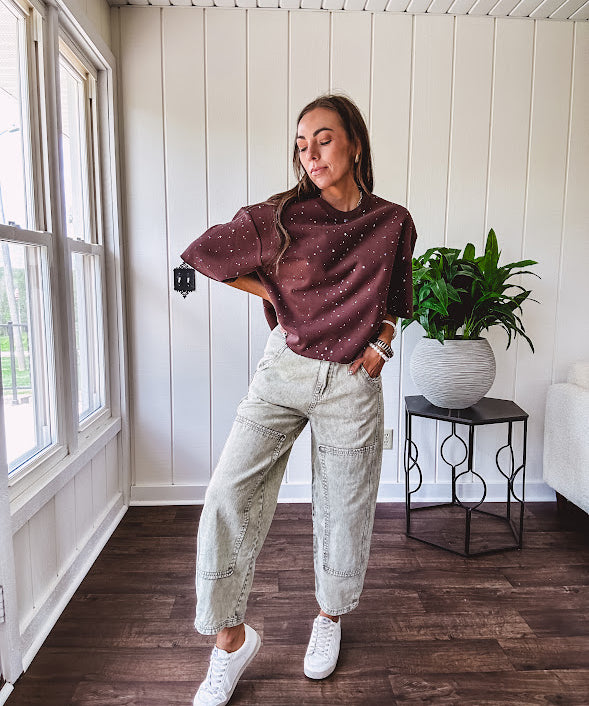 Mineral washed light olive denim barrel pants with carpenter design, side pockets and button and zipper closure with elastic back waist.