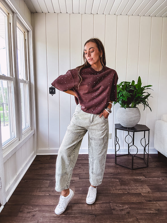 Mineral washed light olive denim barrel pants with carpenter design, side pockets and button and zipper closure with elastic back waist.