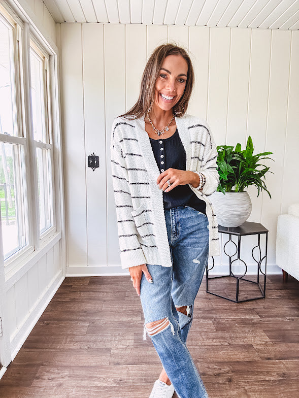 Soft, popcorn textured white cardigan with black striping and side pockets.