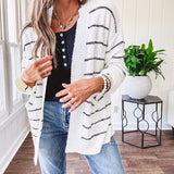 Soft, popcorn textured white cardigan with black striping and side pockets.