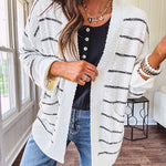 Soft, popcorn textured white cardigan with black striping and side pockets.