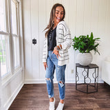 High rise stretch medium wash denim in a mom jean style with distressing at the knees and ankles, skinny design.