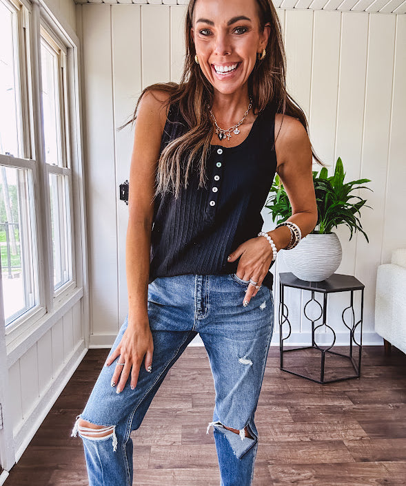 Soft black ribbed textured round neck wide strap tank with 1/4 abalone buttons down the front and relaxed fit.