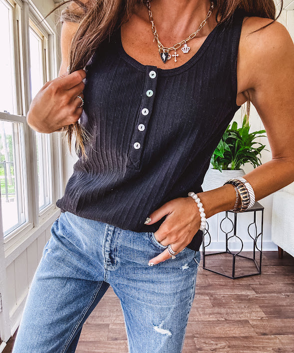 Soft black ribbed textured round neck wide strap tank with 1/4 abalone buttons down the front and relaxed fit.