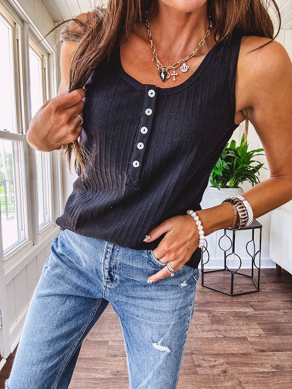 Soft black ribbed textured round neck wide strap tank with 1/4 abalone buttons down the front and relaxed fit.