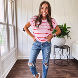 High rise stretch medium wash denim in a mom jean style with distressing at the knees and ankles, skinny design.