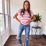 Lightweight woven sweater in blush pink with orange stripes, capped sleeves and a relaxed fit.