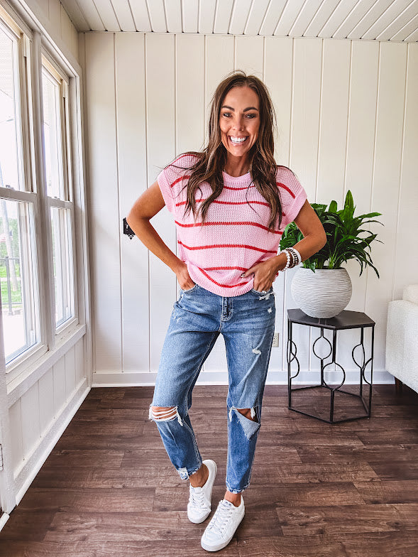 Lightweight woven sweater in blush pink with orange stripes, capped sleeves and a relaxed fit.