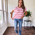 Lightweight woven sweater in blush pink with orange stripes, capped sleeves and a relaxed fit.