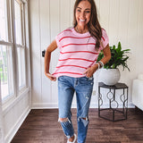 Lightweight woven sweater in blush pink with orange stripes, capped sleeves and a relaxed fit.