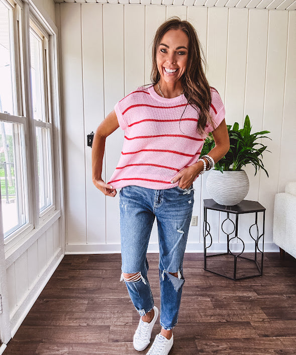 Lightweight woven sweater in blush pink with orange stripes, capped sleeves and a relaxed fit.