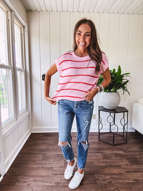Lightweight woven sweater in blush pink with orange stripes, capped sleeves and a relaxed fit.