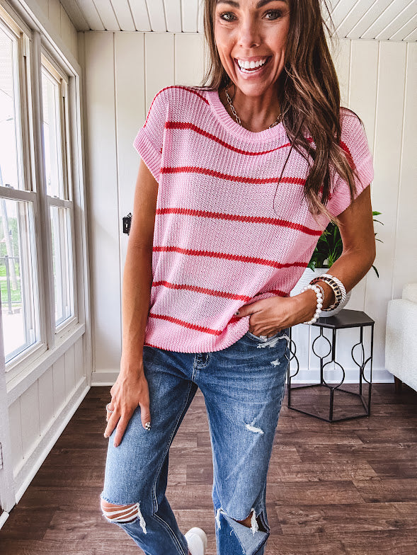 Lightweight woven sweater in blush pink with orange stripes, capped sleeves and a relaxed fit.
