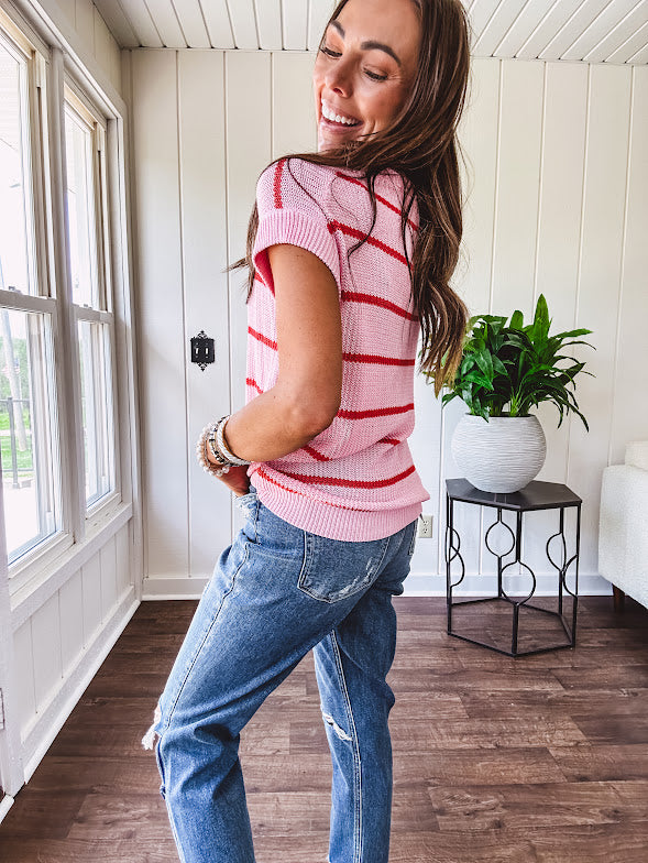 Lightweight woven sweater in blush pink with orange stripes, capped sleeves and a relaxed fit.