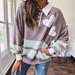 Washed terry knit slate grey pullover with white collar, and 3 snap button placket and heart patchwork and embroidery with Rugby style waffle texture striping detail and pockets.
