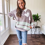 Washed terry knit slate grey pullover with white collar, and 3 snap button placket and heart patchwork and embroidery with Rugby style waffle texture striping detail and pockets.