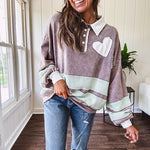 Washed terry knit slate grey pullover with white collar, and 3 snap button placket and heart patchwork and embroidery with Rugby style waffle texture striping detail and pockets.