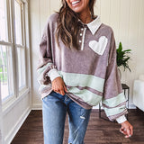 Washed terry knit slate grey pullover with white collar, and 3 snap button placket and heart patchwork and embroidery with Rugby style waffle texture striping detail and pockets.
