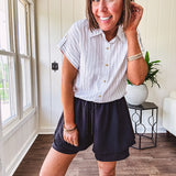 Thin, flowy black shorts with elastic drawstring waist and double layer hemline.