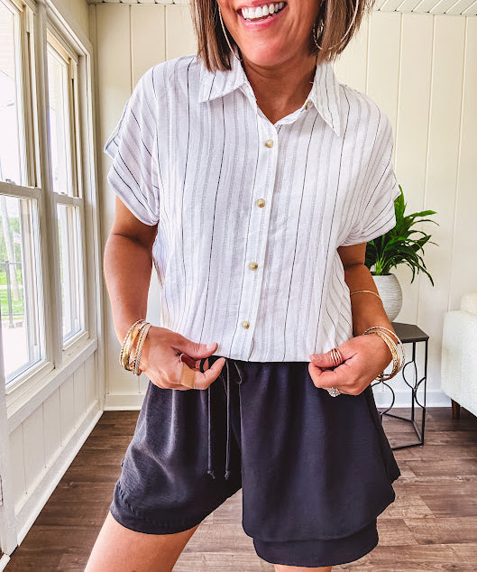 Thin, flowy black shorts with elastic drawstring waist and double layer hemline.