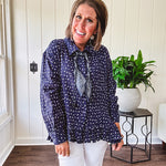Navy gauze button down long sleeved top featuring a ruffled hem, front pocket and matching navy paisley scarf tie.