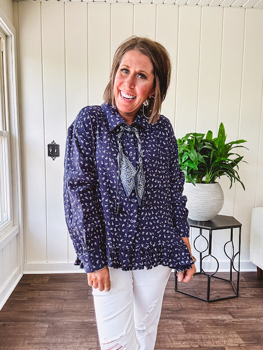 Navy gauze button down long sleeved top featuring a ruffled hem, front pocket and matching navy paisley scarf tie.