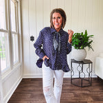 Navy gauze button down long sleeved top featuring a ruffled hem, front pocket and matching navy paisley scarf tie.