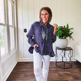 Navy gauze button down long sleeved top featuring a ruffled hem, front pocket and matching navy paisley scarf tie.