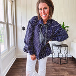 Navy gauze button down long sleeved top featuring a ruffled hem, front pocket and matching navy paisley scarf tie.